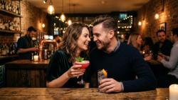 Young couple flirting at a stylish bar in the UK